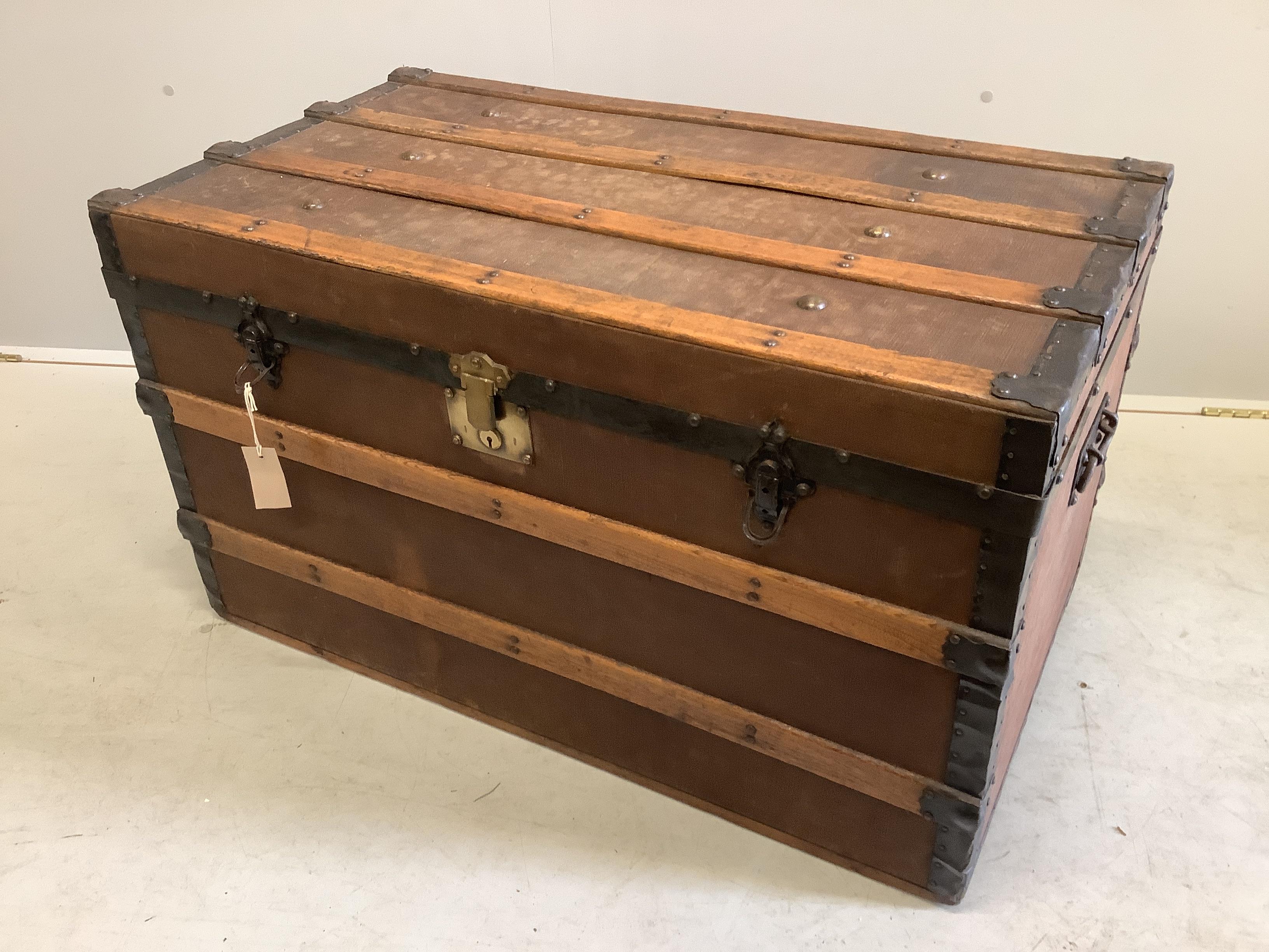 An early 20th century studded canvas covered travelling trunk, width 92cm, depth 50cm, height 53cm